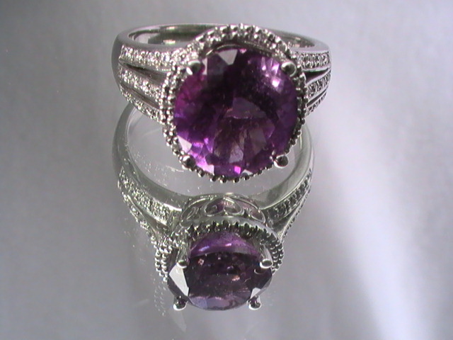 Silver ring set with an oval deep-purple amethyst