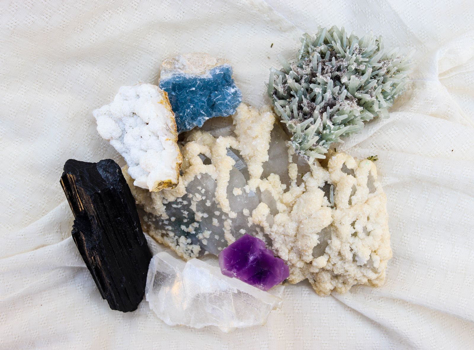Collection of natural mineral specimens including amethyst and quartz