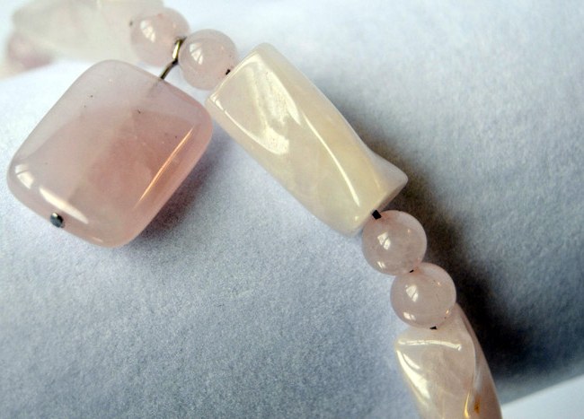 Rose quartz beads showing natural colour variation