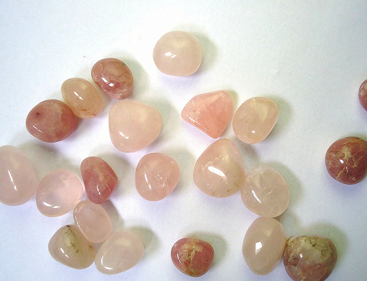 Tumbled rose quartz stones in natural shades of pink